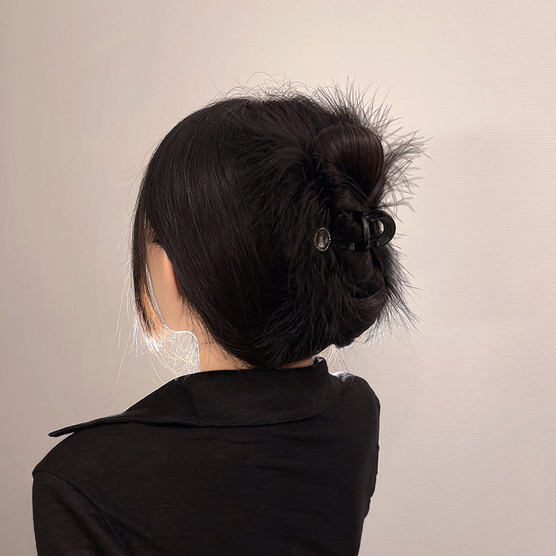 Feather Grabbing Ostrich Feathers On The Back Of The Head