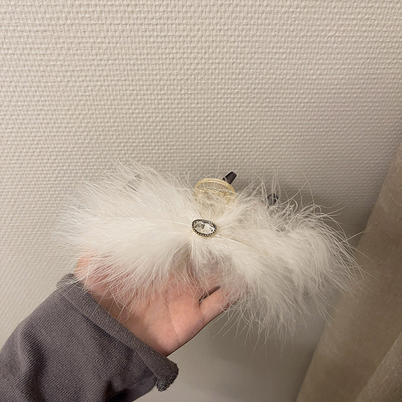 Feather Grabbing Ostrich Feathers On The Back Of The Head
