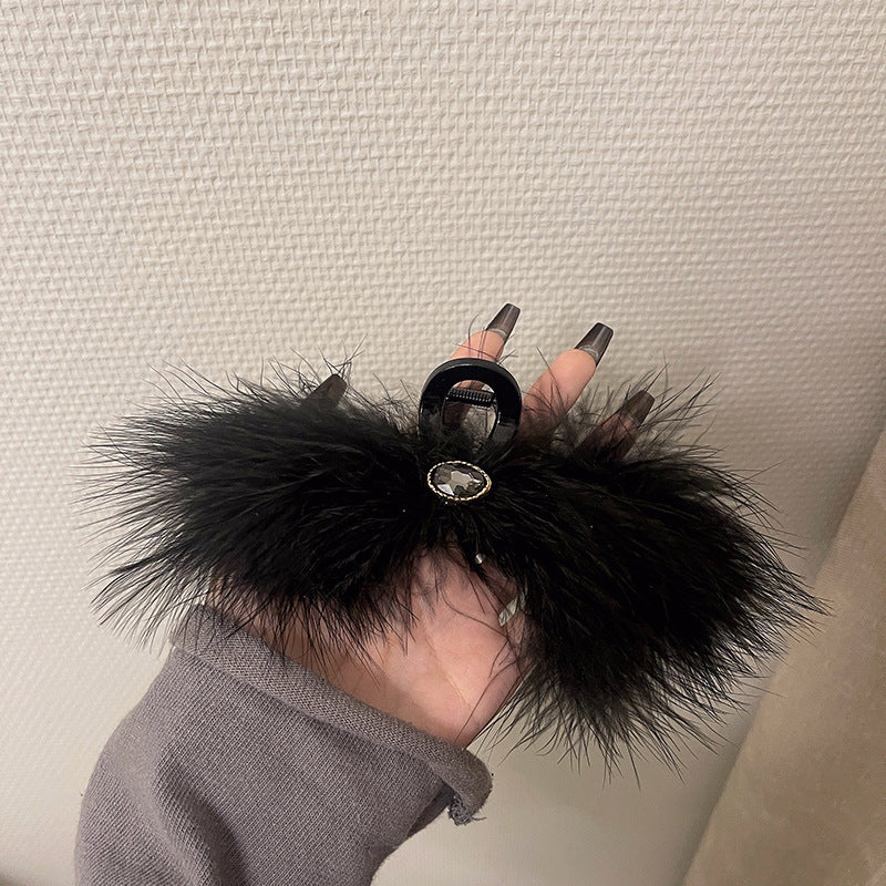 Feather Grabbing Ostrich Feathers On The Back Of The Head